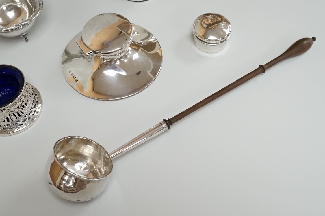 A George V silver mounted capstan inkwell, A & J Zimmerman Ltd, Birmingham, 1913, diameter 11.4cm, together with a small silver bowl, a small silver 'dish ring' salt(a.f.), a silver two handled bowl, a silver pill box an